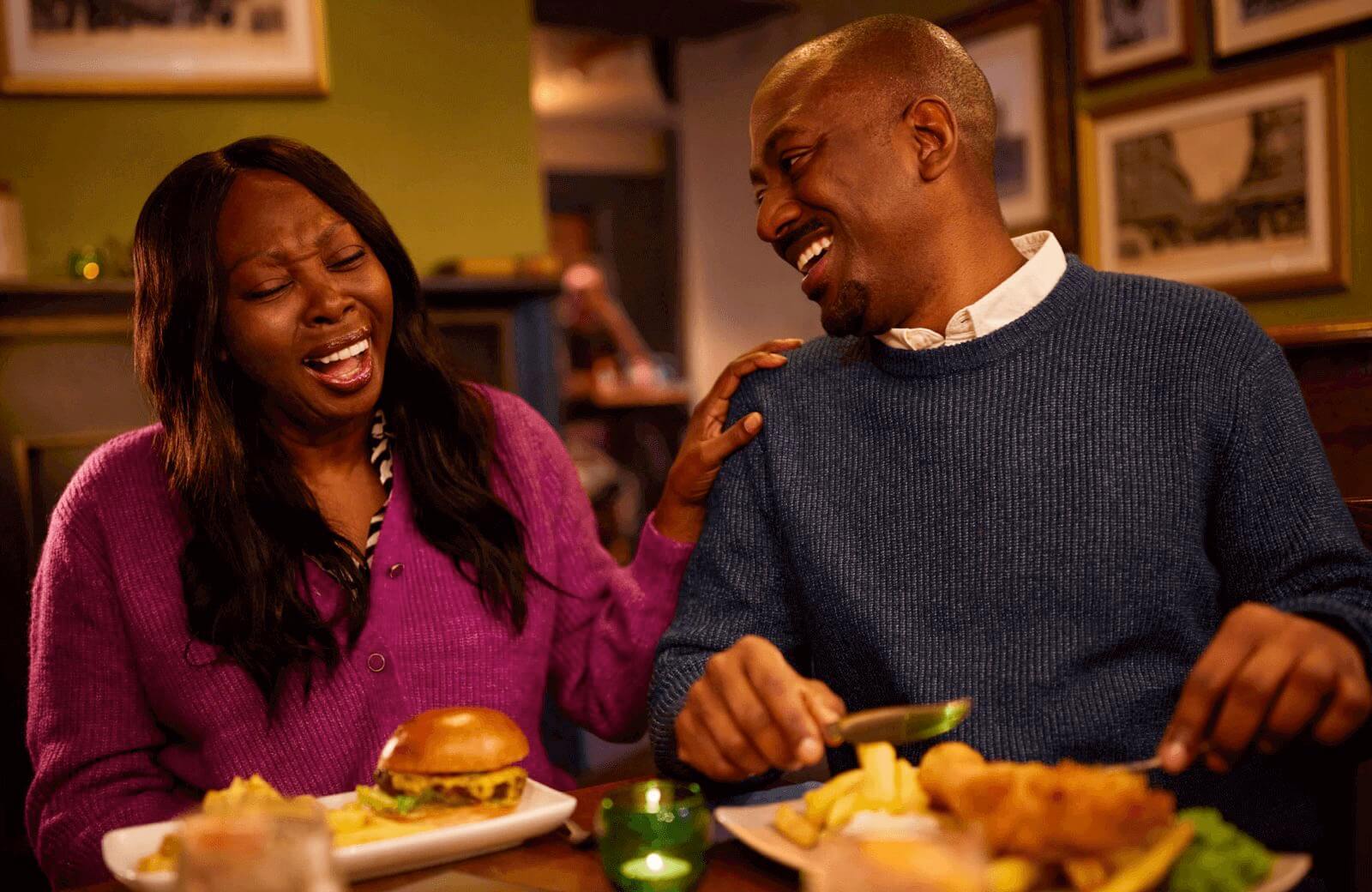 Two people at a restaurant laughing